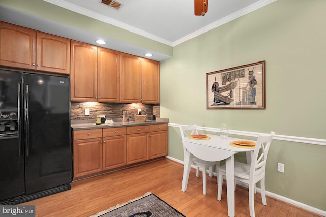 13824 Custis Sq, Woodbridge, VA 22191 - kitchen with black fridge with ice dispenser, light wood finished floors, baseboards, ornamental molding, and backsplash