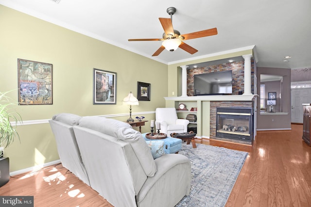 13824 Custis Sq, Woodbridge, VA 22191 - living room featuring a fireplace, ceiling fan, wood finished floors, and crown molding