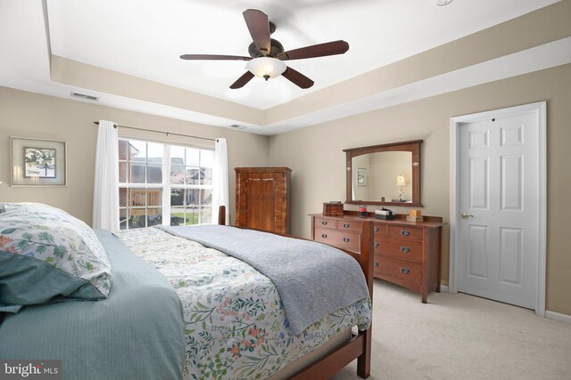 13824 Custis Sq, Woodbridge, VA 22191 - bedroom featuring baseboards, a raised ceiling, visible vents, a ceiling fan, and light carpet