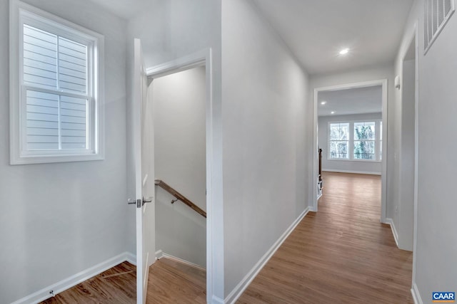 2963 Rambling Brook Ln, Crozet, VA 22932 - hall featuring wood finished floors, visible vents, baseboards, and an upstairs landing