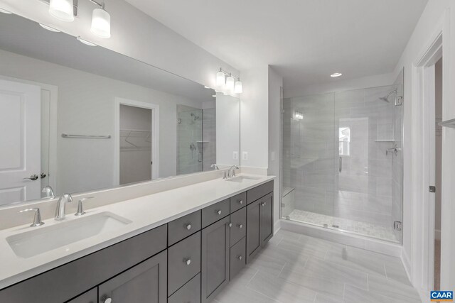 2963 Rambling Brook Ln, Crozet, VA 22932 - bathroom featuring a sink, a walk in closet, a shower stall, and double vanity