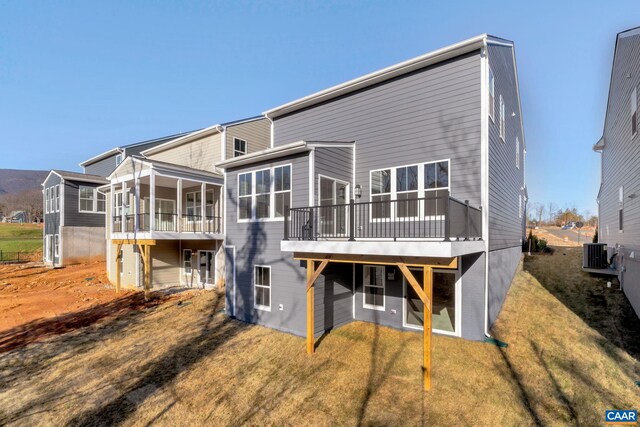 2963 Rambling Brook Ln, Crozet, VA 22932 - back of house featuring a wooden deck, cooling unit, a sunroom, and a lawn