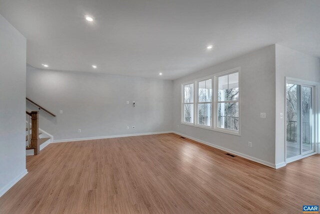 2963 Rambling Brook Ln, Crozet, VA 22932 - unfurnished living room featuring visible vents, baseboards, light wood-type flooring, recessed lighting, and stairs