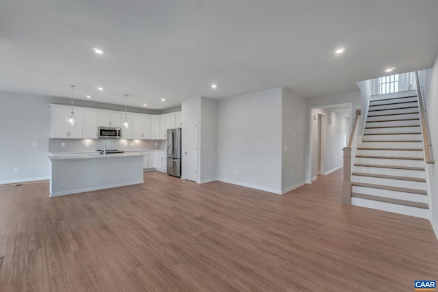 3041 Rambling Brook Ln, Crozet, VA 22932 - kitchen featuring open floor plan, light countertops, appliances with stainless steel finishes, and baseboards
