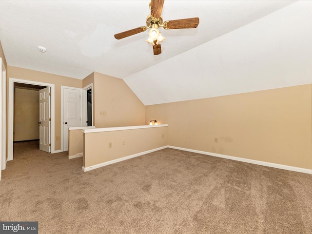 bonus room featuring baseboards, ceiling fan, carpet, and vaulted ceiling