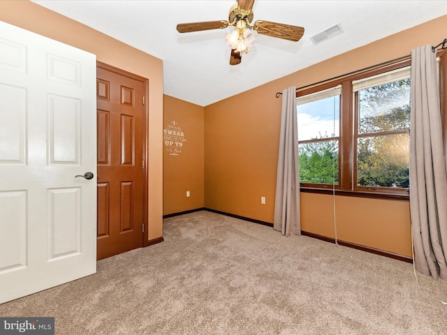 unfurnished bedroom with carpet, visible vents, baseboards, and a ceiling fan