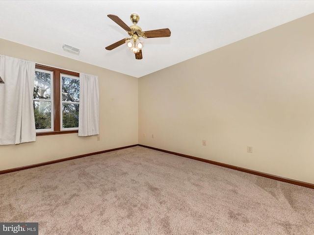 empty room featuring baseboards, a ceiling fan, visible vents, and carpet floors