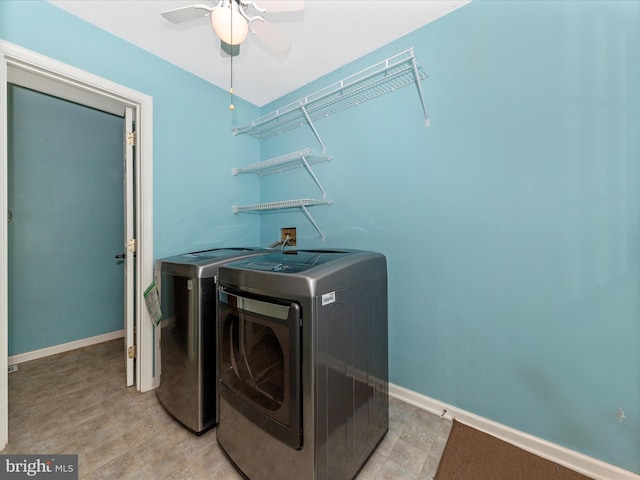 clothes washing area featuring laundry area, baseboards, a ceiling fan, and washer and clothes dryer