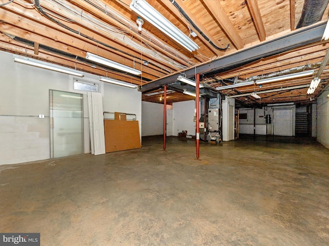unfinished basement featuring heating unit