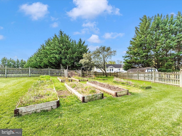 view of yard with a fenced backyard and a vegetable garden
