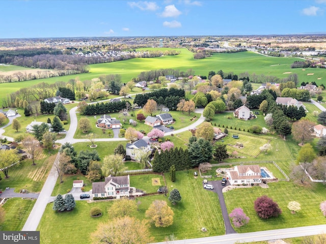 drone / aerial view with view of golf course and a residential view