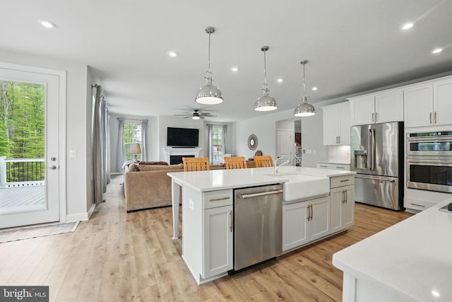 187 Boxelder Dr, Stafford, VA 22554 - kitchen with a sink, a ceiling fan, light countertops, an island with sink, and appliances with stainless steel finishes