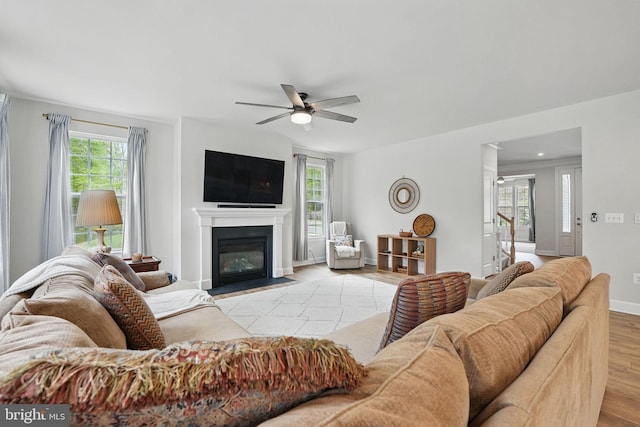 187 Boxelder Dr, Stafford, VA 22554 - living room with a fireplace with flush hearth, baseboards, a ceiling fan, wood finished floors, and stairs