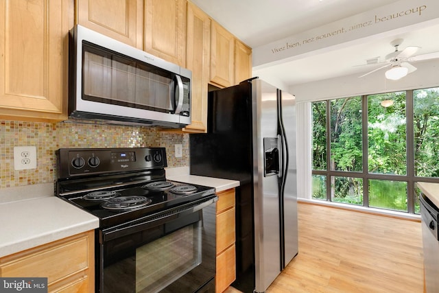 8131 Needwood Rd Unit 102, Derwood, MD 20855 - kitchen with stainless steel appliances, light brown cabinetry, tasteful backsplash, light countertops, and ceiling fan