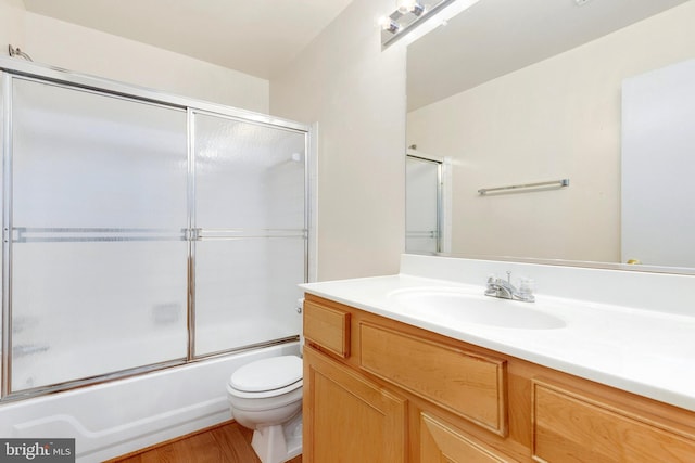 8131 Needwood Rd Unit 102, Derwood, MD 20855 - bathroom featuring vanity, toilet, bath / shower combo with glass door, and wood finished floors