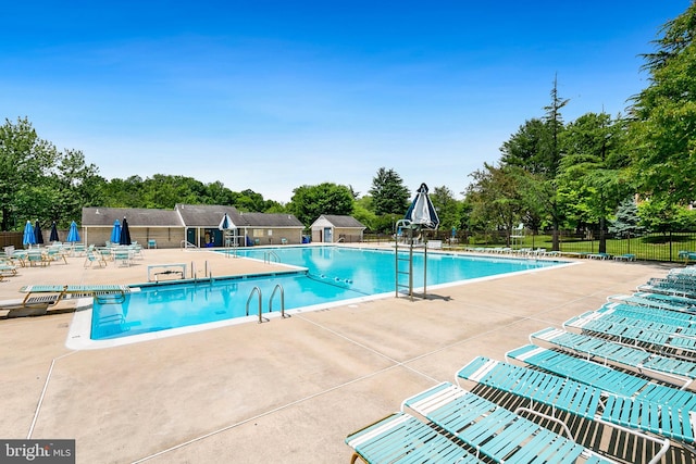 8131 Needwood Rd Unit 102, Derwood, MD 20855 - community pool featuring a patio and view of scattered trees