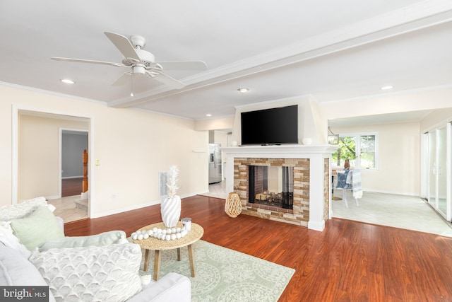 3188 Windrows Way, Eden, MD 21822 - living room with ornamental molding, a stone fireplace, a ceiling fan, recessed lighting, and wood finished floors