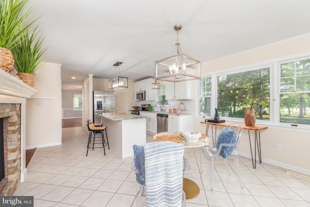 3188 Windrows Way, Eden, MD 21822 - kitchen featuring appliances with stainless steel finishes, a sink, a chandelier, a kitchen island with sink, and white cabinetry