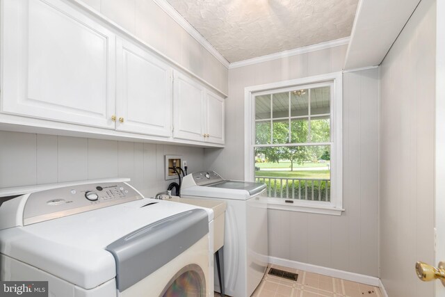 3188 Windrows Way, Eden, MD 21822 - laundry area with cabinet space, washing machine and dryer, baseboards, ornamental molding, and a textured ceiling
