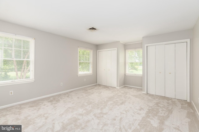 3188 Windrows Way, Eden, MD 21822 - unfurnished bedroom featuring multiple closets, multiple windows, and carpet flooring