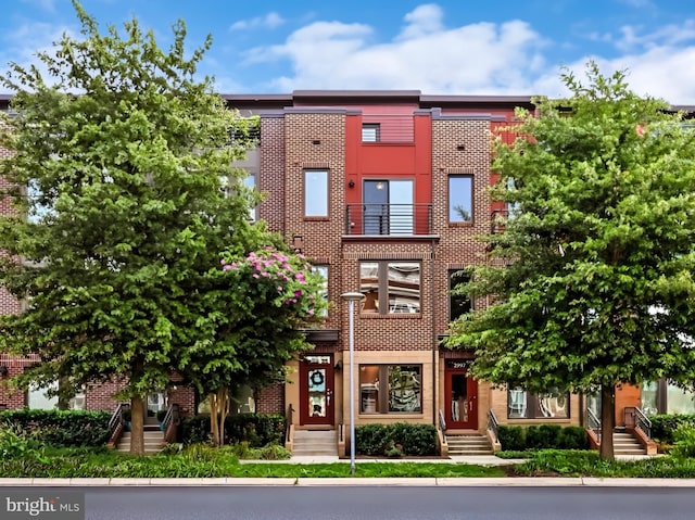 townhome / multi-family property with brick siding