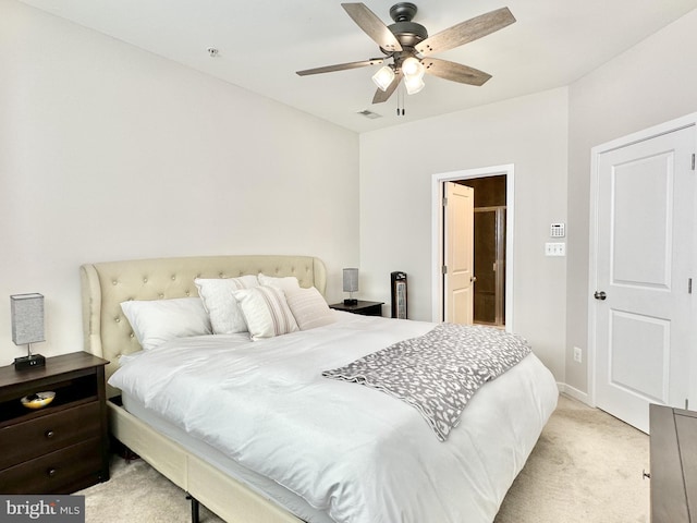 bedroom with a ceiling fan, visible vents, and light colored carpet