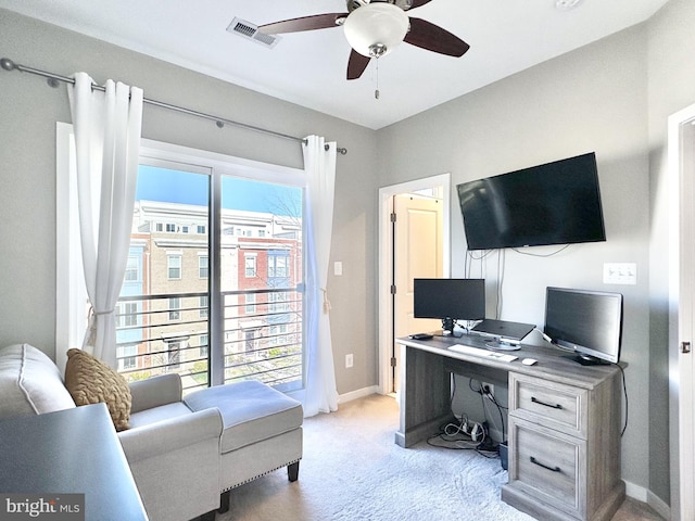office area featuring light colored carpet, ceiling fan, baseboards, and visible vents