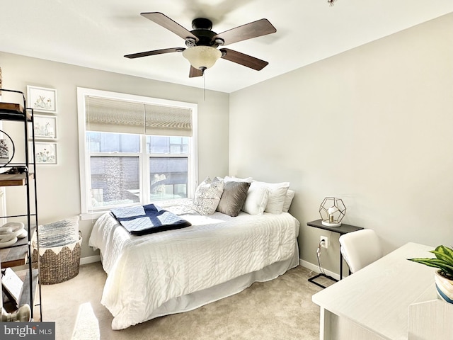 bedroom with baseboards, light carpet, and a ceiling fan
