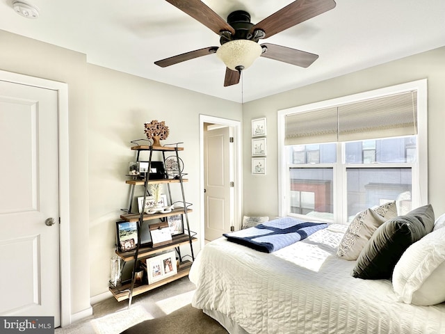 bedroom with carpet floors, baseboards, and a ceiling fan