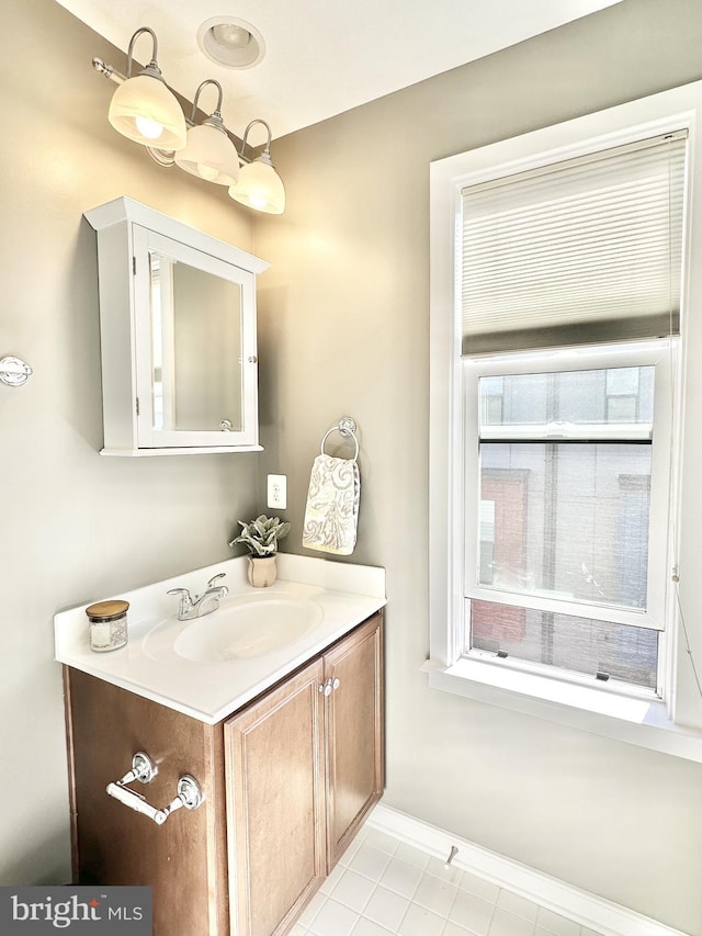 bathroom featuring vanity, baseboards, and tile patterned flooring