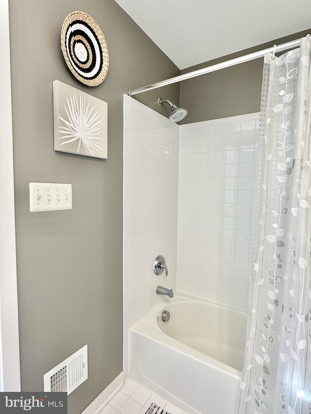 bathroom featuring baseboards, tile patterned floors, shower / tub combo, and visible vents