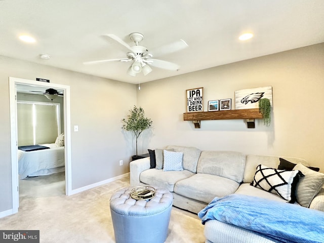 carpeted living area with a ceiling fan, baseboards, and recessed lighting