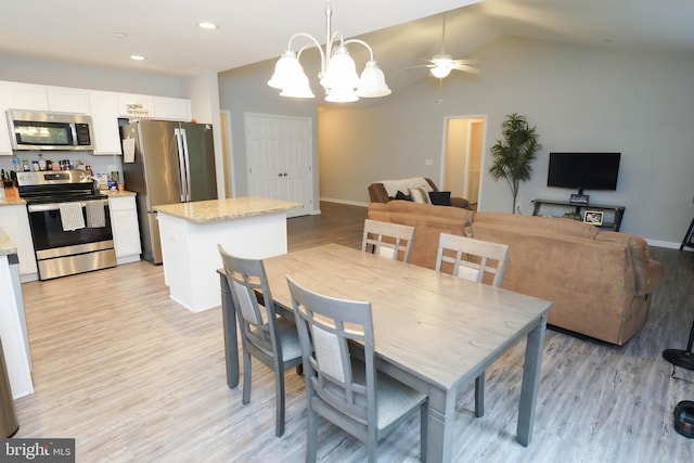 dining space featuring vaulted ceiling, baseboards, ceiling fan with notable chandelier, light wood-style floors, and recessed lighting