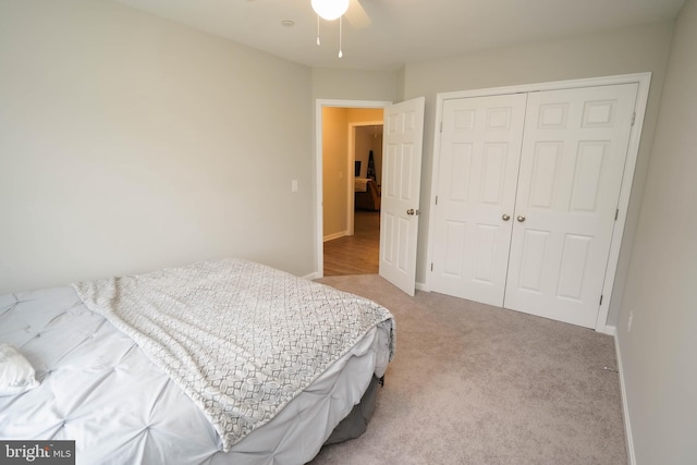 bedroom featuring a closet, carpet flooring, baseboards, and a ceiling fan