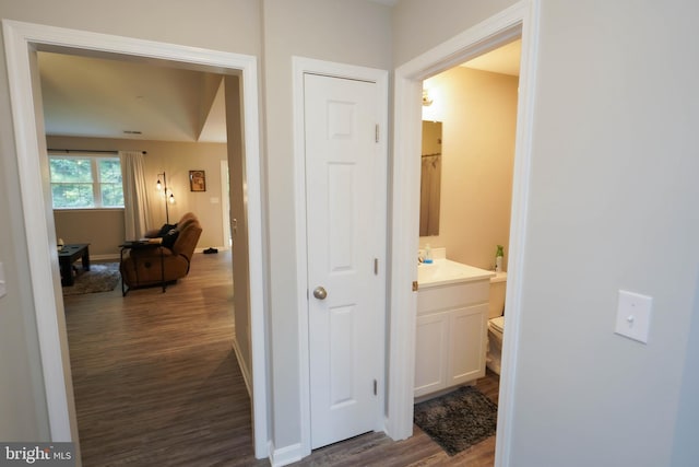 hall with baseboards and dark wood finished floors
