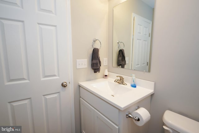 bathroom featuring toilet and vanity