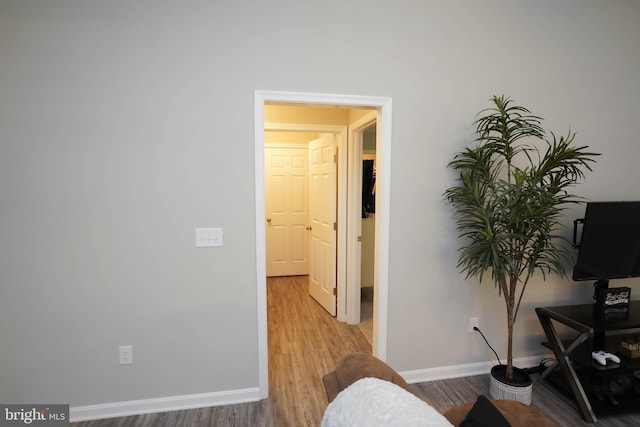 interior space with baseboards and wood finished floors