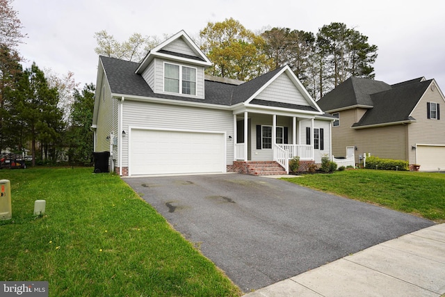view of front of house featuring roof with shingles, a front yard, covered porch, and aphalt driveway