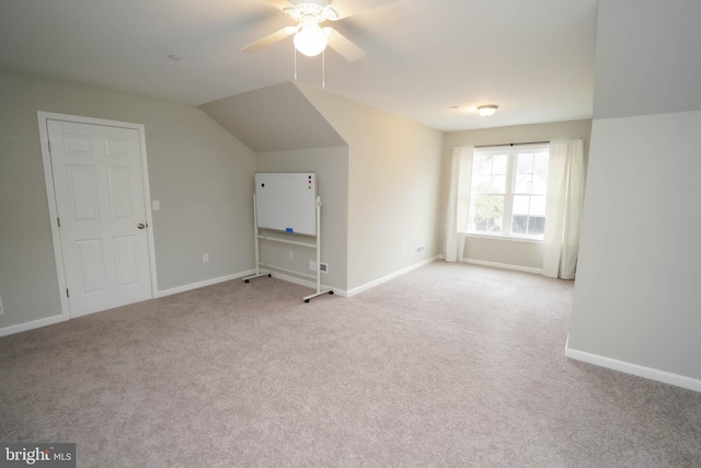 additional living space with baseboards, carpet floors, and ceiling fan