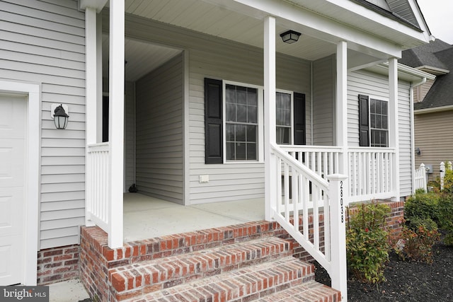 view of exterior entry with covered porch