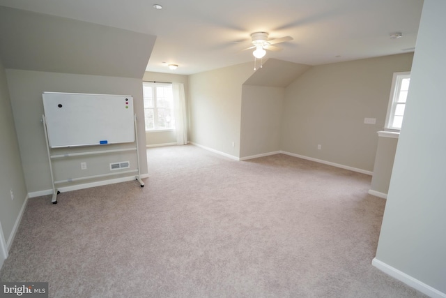 bonus room featuring baseboards, carpet floors, visible vents, and a ceiling fan