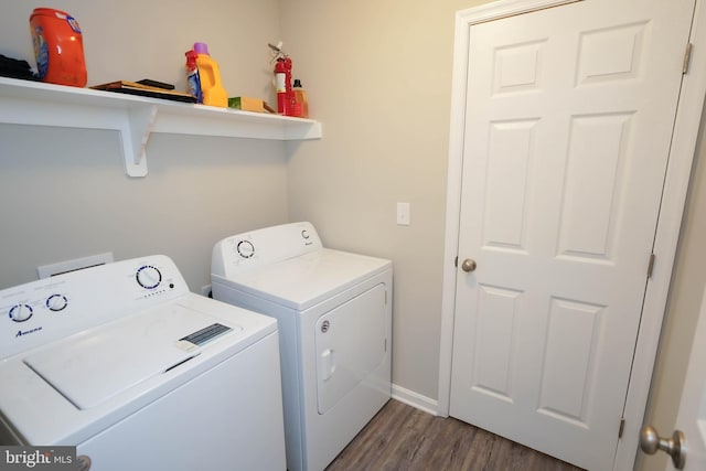 laundry room with dark wood-style floors, separate washer and dryer, laundry area, and baseboards