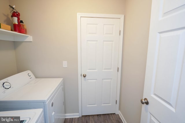 clothes washing area featuring laundry area, dark wood-type flooring, baseboards, and separate washer and dryer