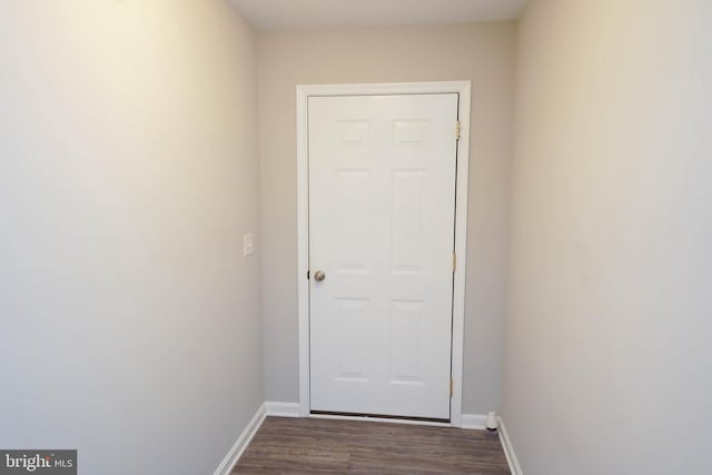 entryway with dark wood-style floors and baseboards