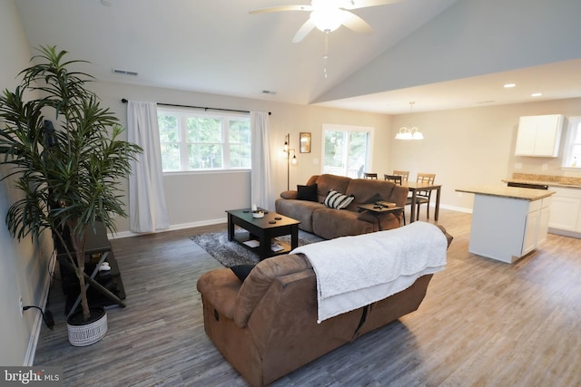 living room with recessed lighting, ceiling fan with notable chandelier, baseboards, light wood-style floors, and visible vents