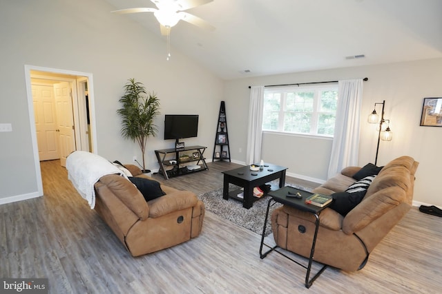 living area featuring vaulted ceiling, baseboards, visible vents, a ceiling fan, and wood finished floors