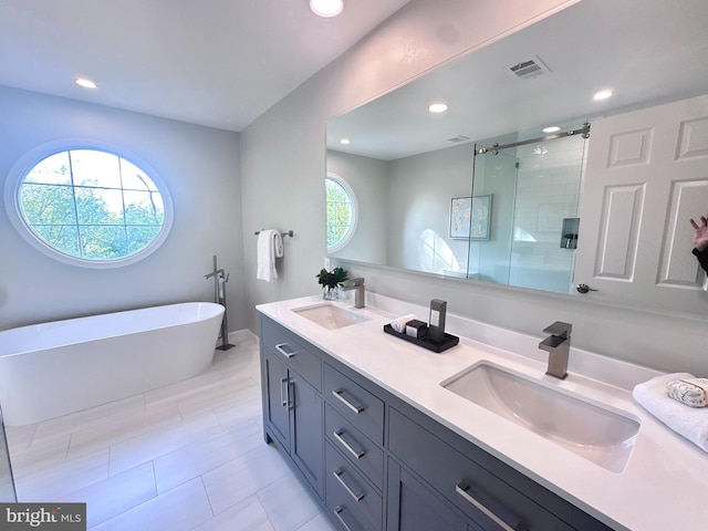 bathroom featuring visible vents, a sink, recessed lighting, and a shower stall