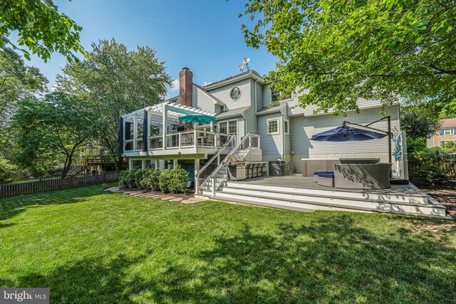 rear view of property with a fenced backyard, a wooden deck, a chimney, and stairway