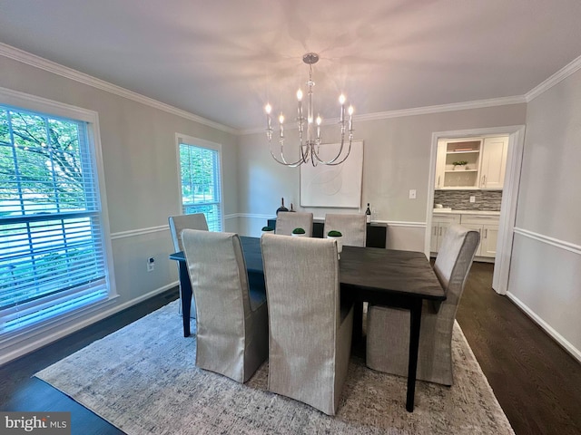 dining space with crown molding, baseboards, a chandelier, and dark wood-style floors
