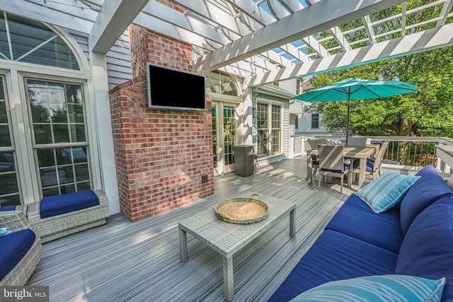 wooden terrace featuring outdoor lounge area, a pergola, and outdoor dining space